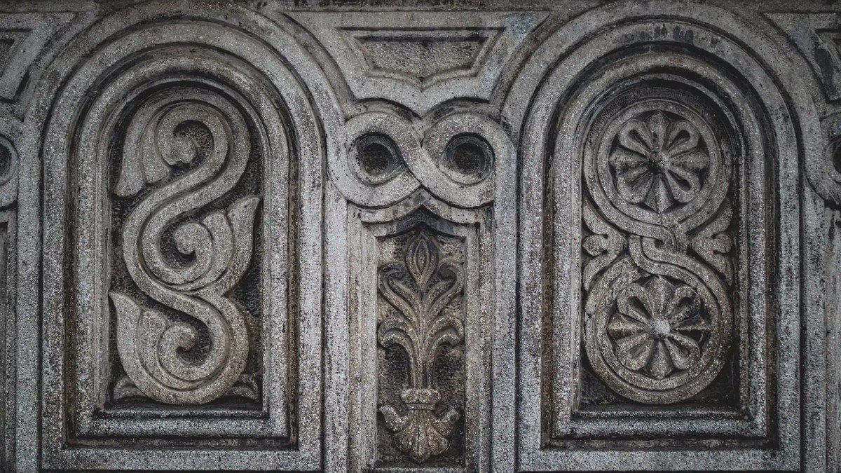 Detail ukiran kayu pada tiang dan dinding Nuwo Sesat rumah adat Lampung
